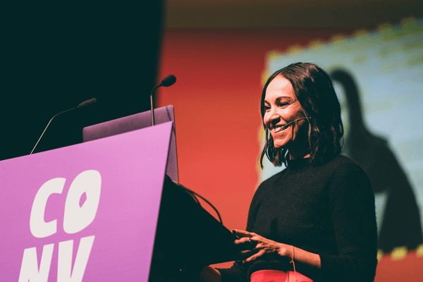 Close-up of Natalie Hernandez speaking on stage at Converge Brighton 2024.