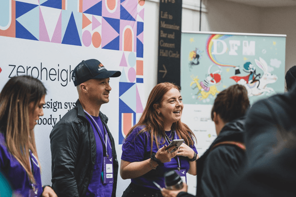 Three zeroheight staff members working at their display stand during the breaks at Converge Brighton 2024.
