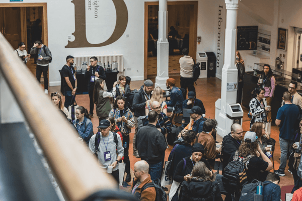 Bird’s-eye view of Converge Brighton 2024 attendees networking during the tea and coffee break.